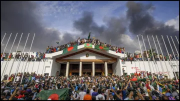 People gather around the residence of Bangladeshi prime minister in Dhaka, Bangladesh.