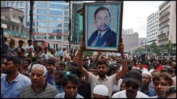 Supporter of Bangladesh Nationalist Party (BNP) holds a picture of former President Ziaur Rahman in a rally.