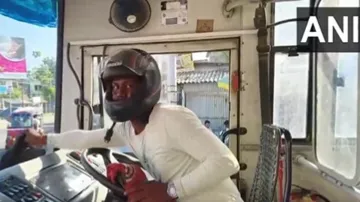 Drivers of state-run buses wear helmet