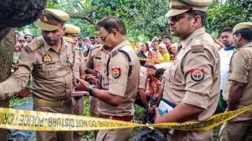 UP Police investigates the death of two girls after their bodies were found hanging on a tree at Kayamganj area in Farrukhabad on August 27, 2024. 