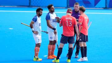 Harmanpreet Singh sees the umpire talking to Britain's Sam Ward.