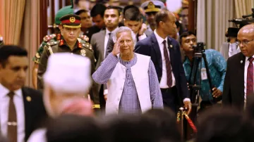 Nobel laureate Muhammad Yunus salutes to the attendees upon arrival at the Bangabhaban to take oath 