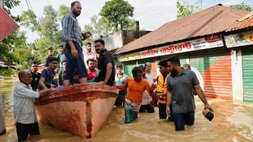 People move on a boat due to severe flooding in the Chhagalnaiya area, in Feni