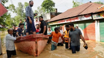 People move on a boat due to severe flooding in the Chhagalnaiya area, in Feni