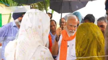 PM Modi interacts with farmers while it rains