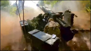 A Russian soldier fires from a D-30 howitzer towards Ukrainian positions in an undisclosed location in Ukraine.