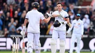 Jamie Smith celebrates his century with Gus Atkinson.