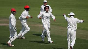 Rashid Khan celebrates a wicket with his Afghan teammates.