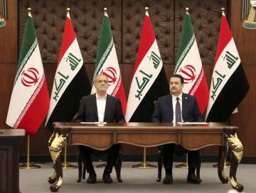 Iranian President Masoud Pezeshkian and Iraqi Prime Minister Mohammed Shia al-Sudani attend the sign