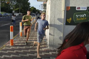 Israeli citizen rushing towards bunker after air raid siren 