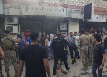 Smoke rises from explosions in a mobile shop in Lebanon's Sidon