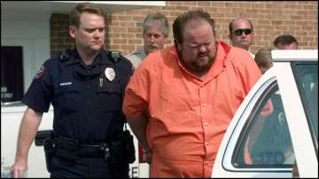 Officials escort murder suspect Alan Eugene Miller away from the Pelham City Jail in Alabama, August 5, 1999.