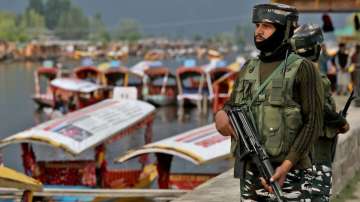 Central Reserve Police Force (CRPF) personnel stand guard on the banks of Dal Lake