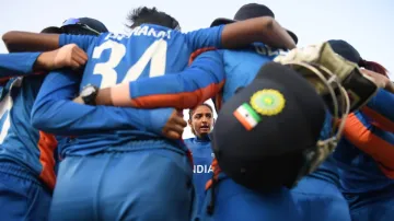 Indian cricket team in a team huddle.