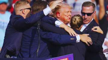 Republican presidential candidate former President Donald Trump is surrounded by US Secret Service a