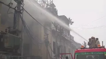 Fire brigade officials douse the fire