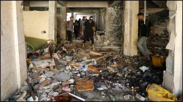 Palestinians inspect a school, which was sheltering displaced people, after it was hit by an Israeli strike on Saturday.