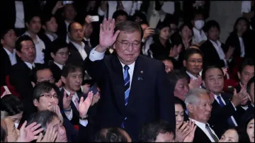 Former Japanese Defence Minister Shigeru Ishiba waves as he is elected as new head of the ruling party in the Liberal Democratic Party's (LDP) leadership vote.