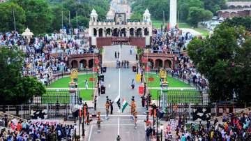 Visitors watch security personnel perform during the beating retreat ceremony at the Attari-Wagah Bo