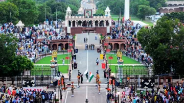 Visitors watch security personnel perform during the beating retreat ceremony at the Attari-Wagah Bo