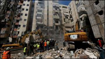 Emergency personnel work at the site of Friday's Israeli strike in Beirut's southern suburbs.