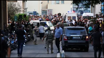 People gather outside a hospital as thousands were injured in pager blasts across Lebanon.