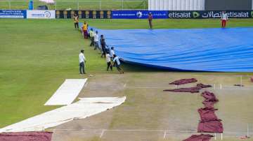 Groundsmen at work at the Greater Noida Sports Complex Ground.