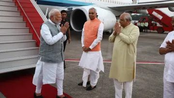 PM Modi is received by Governor Acharya Devvrat and Chief Minister Bhupendra Patel