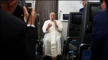 Pope Francis holds a news conference aboard the papal plane.