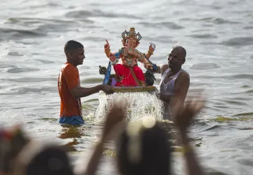 Devotees immerse an idol of Lord Ganesh during Ganpati Visarjan.