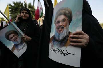 Hezbollah chief Hassan Nasrallah's supporters carrying his posters