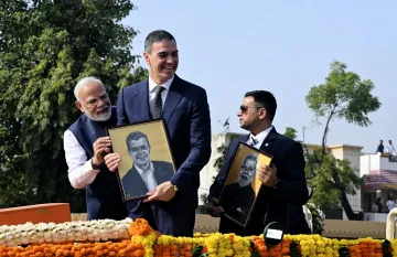 Prime Minister Narendra Modi and Spanish Prime Minister Pedro Sanchez with their portraits during a roadshow in Vadodara
