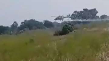 A screen grab from the video shows an IAF helicopter making an emergency landing in a waterlogged area.



