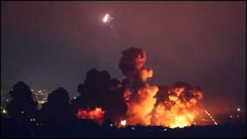 Smoke rises following an explosion over Beirut's southern suburbs after a strike.