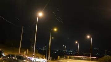 Cars move on a road as projectiles launched from Iran are being intercepted in the skies over the northern Israel.