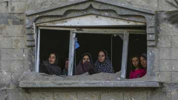 Palestinians look at the destruction site