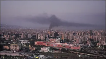 Smoke billows over Beirut's southern suburbs after overnight strikes by Israel.