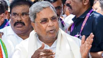 Karnataka Chief Minister Siddaramaiah speaks with the media outside his residence.