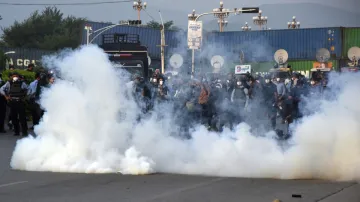 Police officers fire tear gas to disperse the supporters of imprisoned former Prime Minister Imran Khan's party 