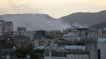 Smoke rises from the site of strikes in Sanaa