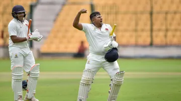 Sarfaraz Khan celebrates his hundred.