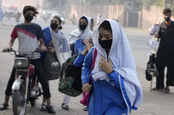 Students wear mask to protect themselves from poor air quality due to increasing smog in the city as