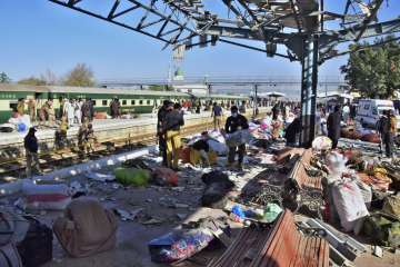 Security officials examine the site of a bomb explosion at railway station in Quetta