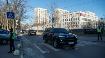 A convoy of cars leaves the U.S. embassy, amid Russia's attack on Ukraine, in Kyiv, Ukraine 