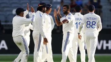 Jasprit Bumrah celebrates a wicket with his teammates.