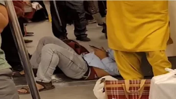 WATCH VIDEO, delhi metro viral video, Man relaxing on Delhi metro floor while using MOBILE phone, ne