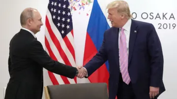 Russia's President Vladimir Putin shakes hands with then US President Donald Trump during a meeting 