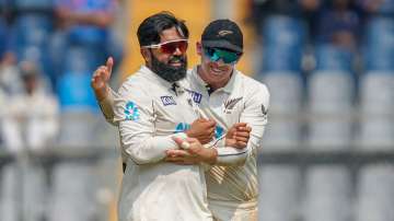 Tom Latham and Ajaz Patel celebrate a wicket on day three of Mumbai Test.