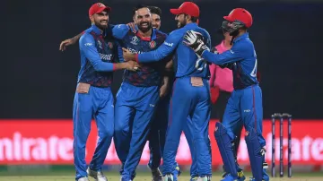 Mohammad Nabi celebrates a wicket with his teammates.