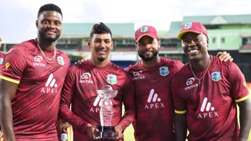 West Indies players pose with the ODI trophy.